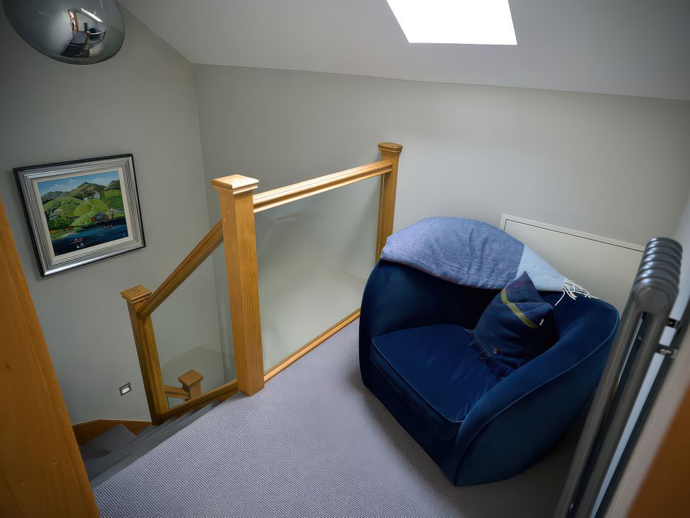 A landing with a chair and artwork at Midways in Bowness-On-Windermere