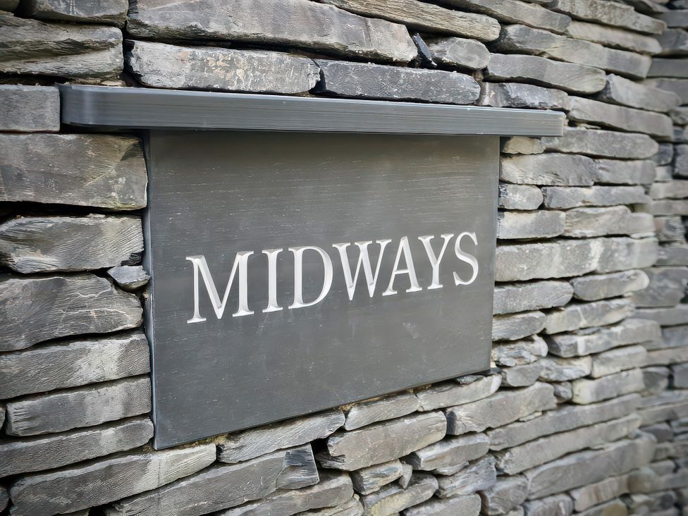 A sign on a stone wall at Midways in Bowness-On-Windermere