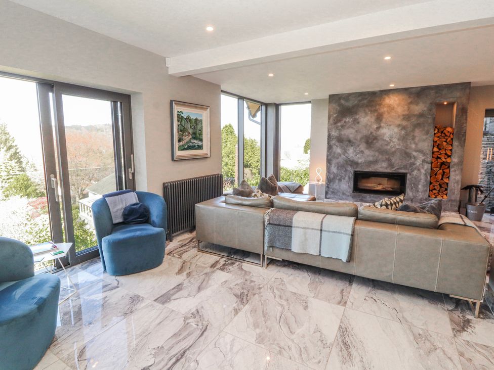 A living room with a sofa and armchairs at Midways in Bowness-On-Windermere