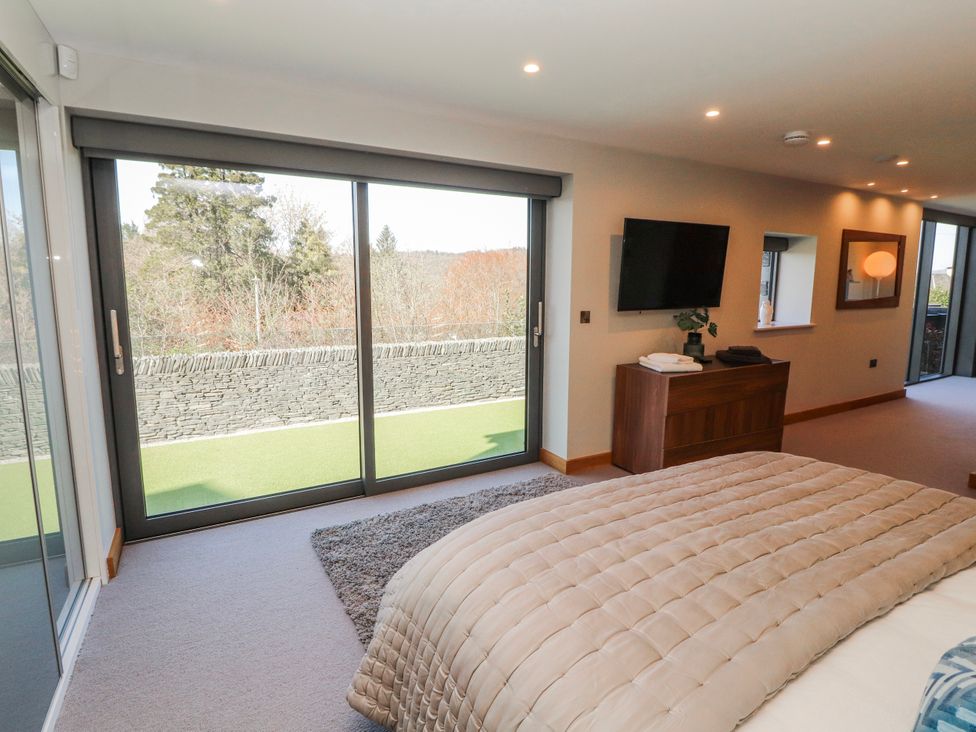 A bedroom with a bed and television at Midways in Bowness-On-Windermere