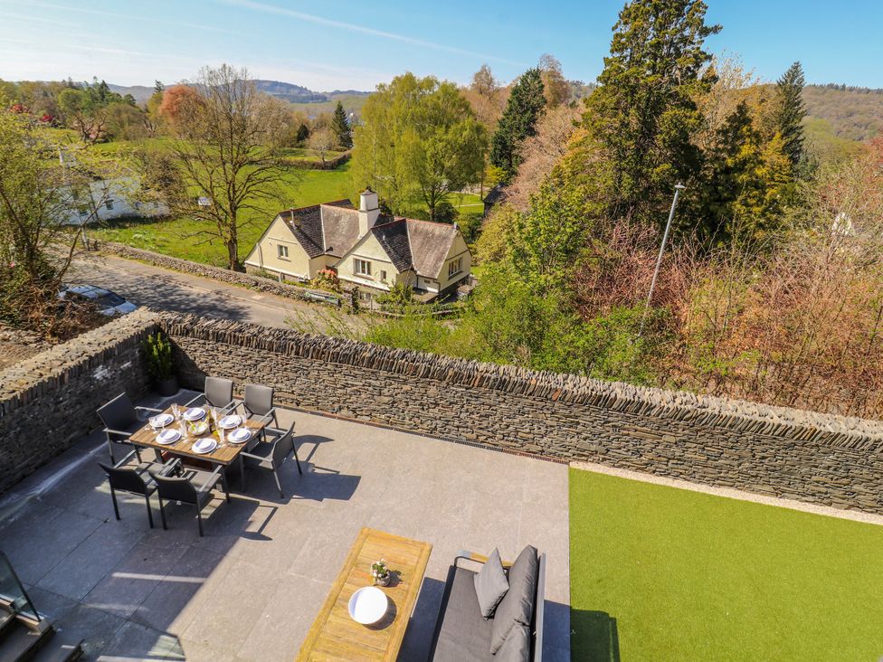 An outdoor patio with a table and chairs at Midways in Bowness-On-Windermere