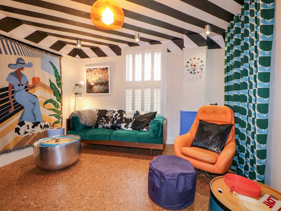 A living room with a couch and armchair at 3 Cinque Ports Street, Rye