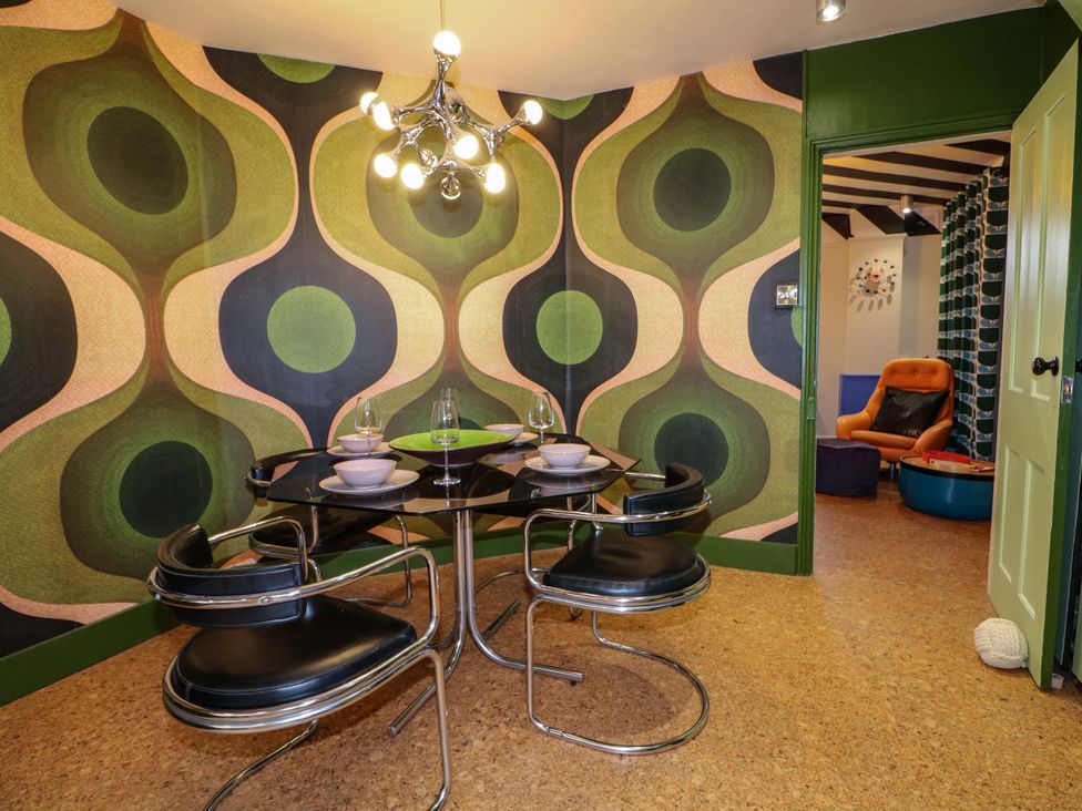 A dining room with a table and chairs at 3 Cinque Ports Street Rye