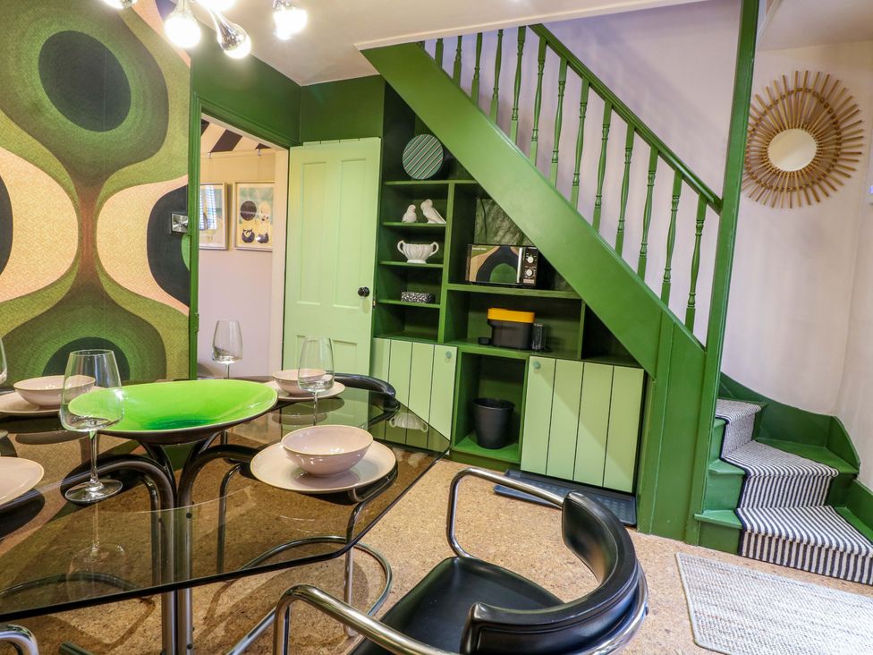 A dining room with a table and chairs at 3 Cinque Ports Street in Rye