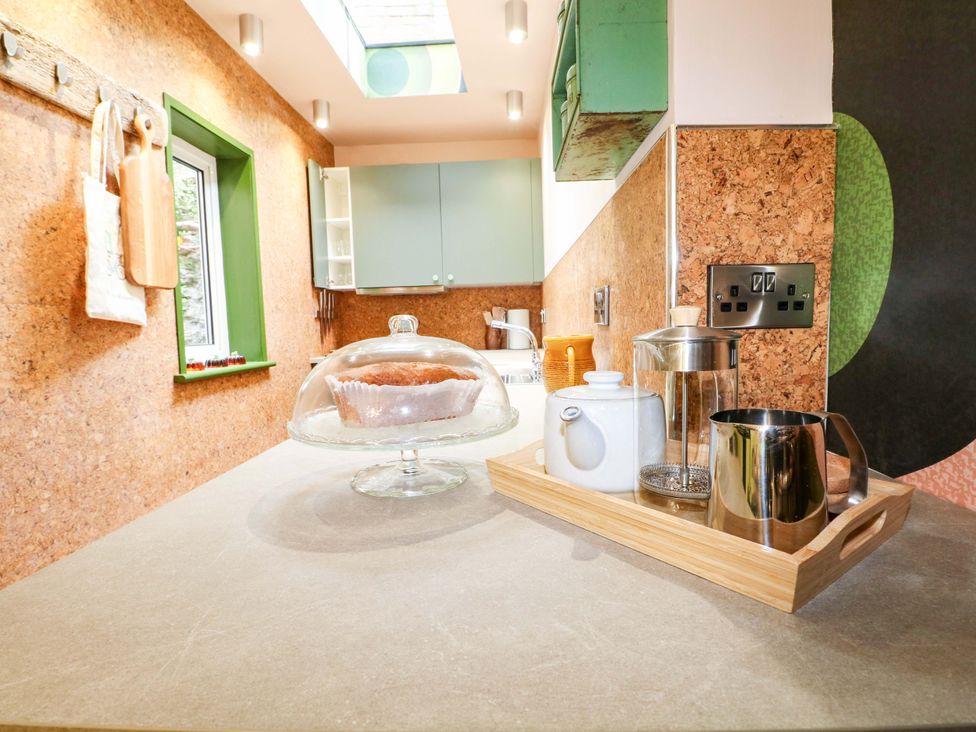 A kitchen with a cake stand and tea set at 3 Cinque Ports Street in Rye