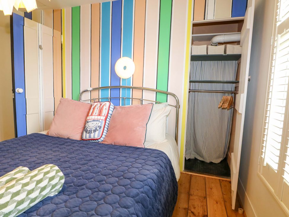 A bedroom with a bed and a wardrobe at 3 Cinque Ports Street in Rye