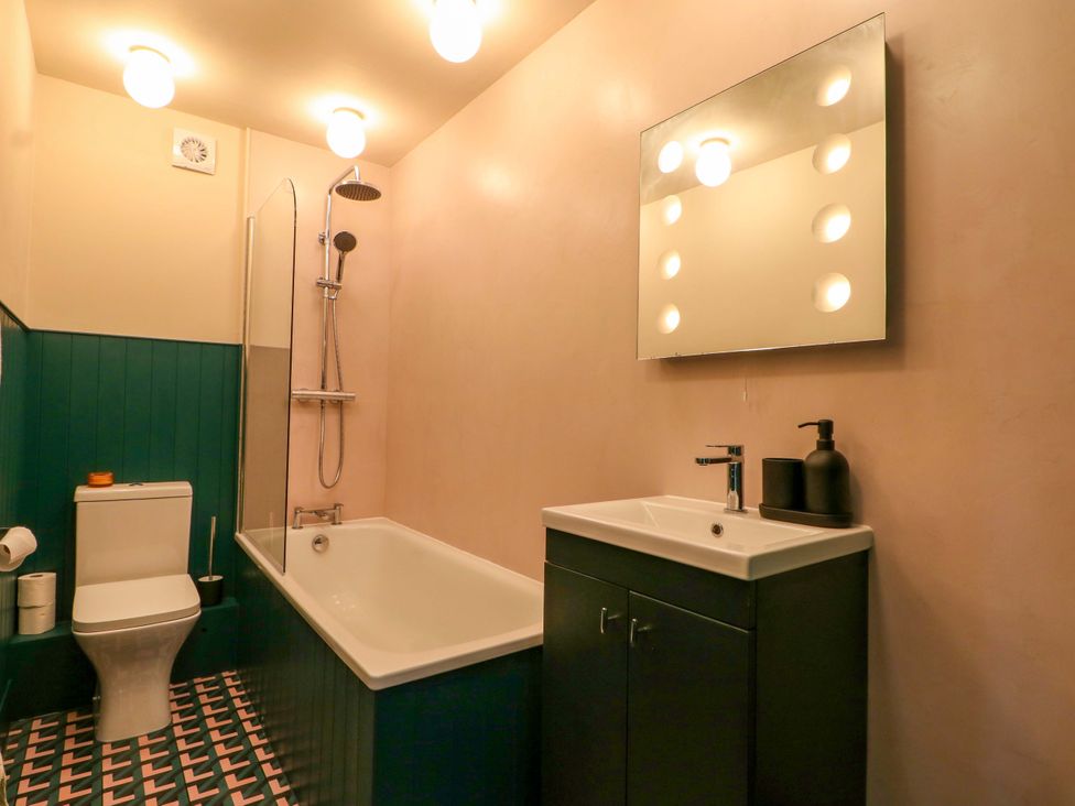A bathroom with a bathtub and sink at 3 Cinque Ports Street, Rye