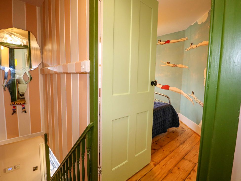 A bedroom with a bed and wall art at 3 Cinque Ports Street in Rye