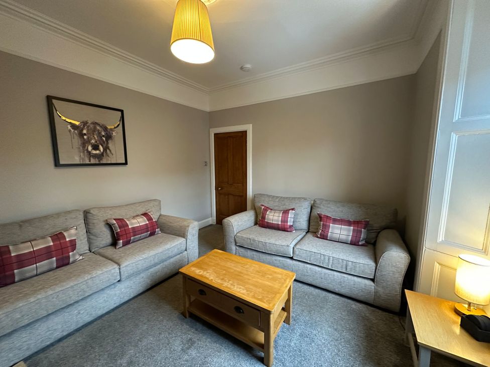 A living room with sofas and a coffee table at The Teviot in Kelso