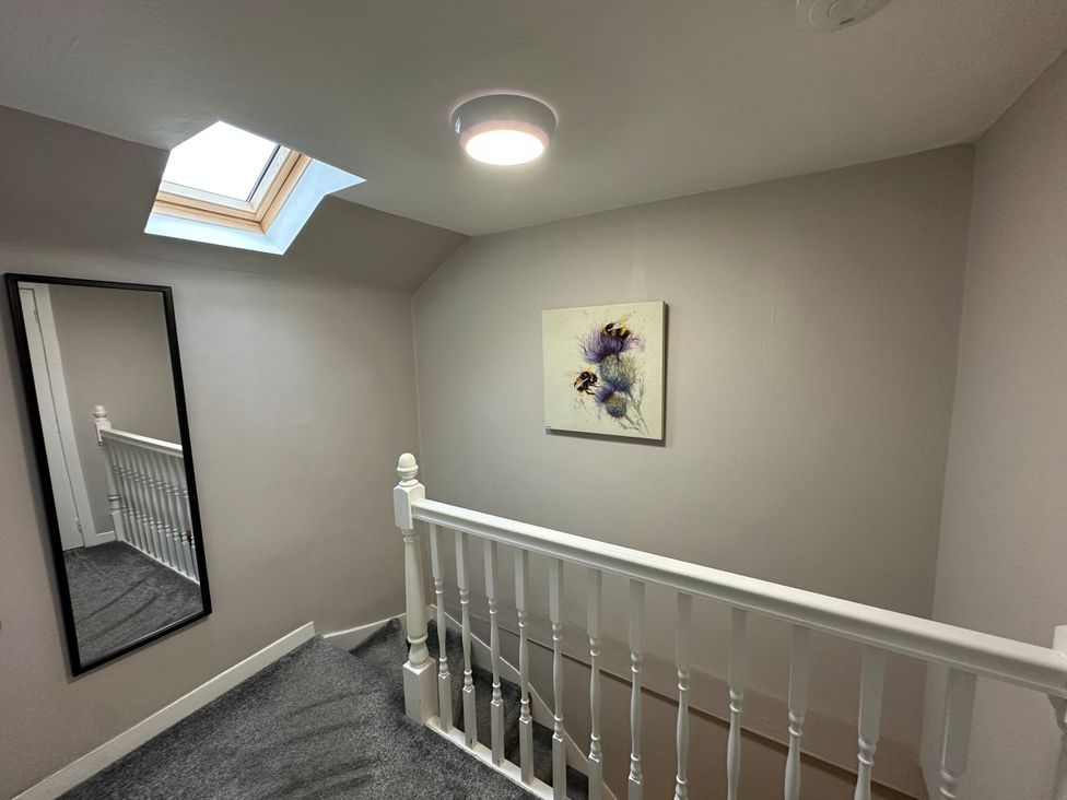 A staircase with a mirror and a skylight at The Teviot in Kelso