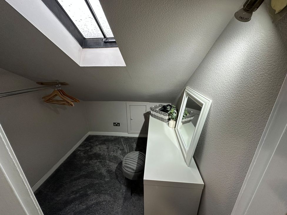 A dressing room with hangers and a mirror at The Teviot in Kelso