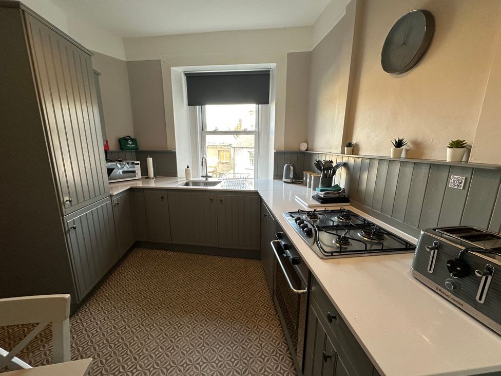 A kitchen with cabinets, sink, stove, and toaster at The Tweed in Melrose
