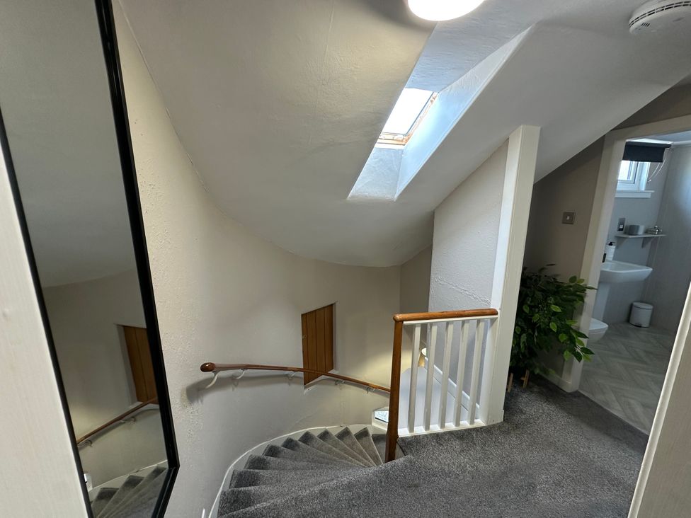 A stairwell with a mirror and a skylight at The Tweed in Melrose
