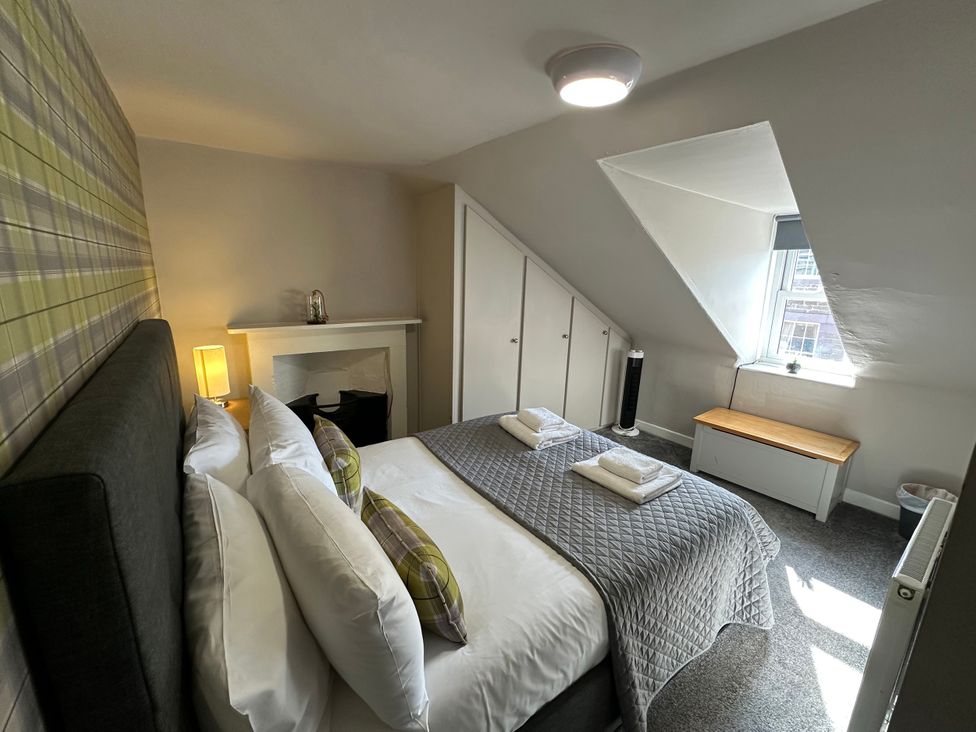 A bedroom with a bed and furniture at The Tweed in Melrose