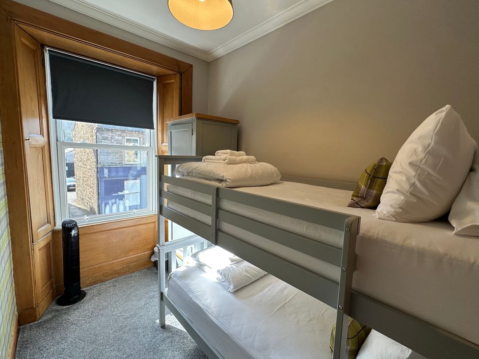 A bedroom with a bunk bed and window at The Tweed in Melrose