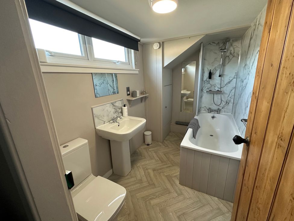 A bathroom with a toilet, sink, bathtub and shower at The Tweed in Melrose