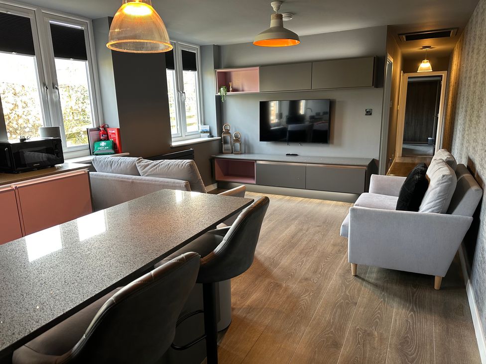 A living room with a television and sofa at The Tay in Melrose