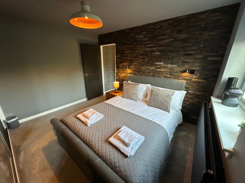 A bedroom with a bed and bedside table at The Tay in Melrose