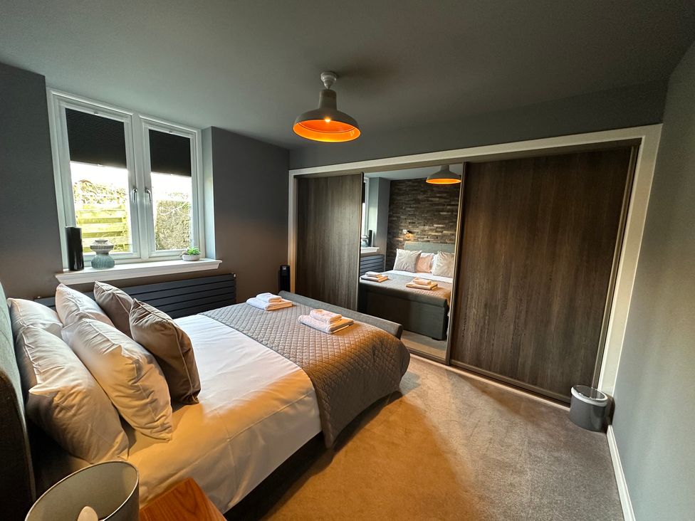 A bedroom with a bed and wardrobe at The Tay in Melrose