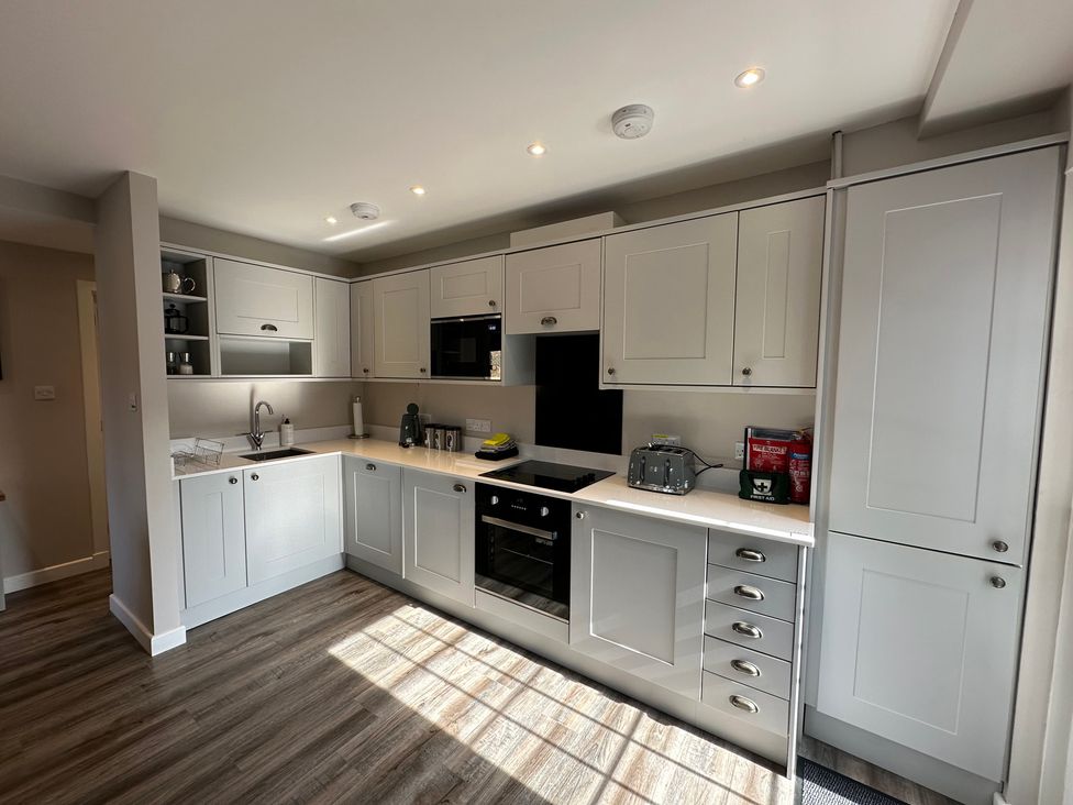 A kitchen with cabinets and appliances at The Esk in Melrose