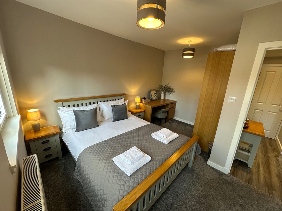 A bedroom with a double bed and desk at The Esk in Melrose