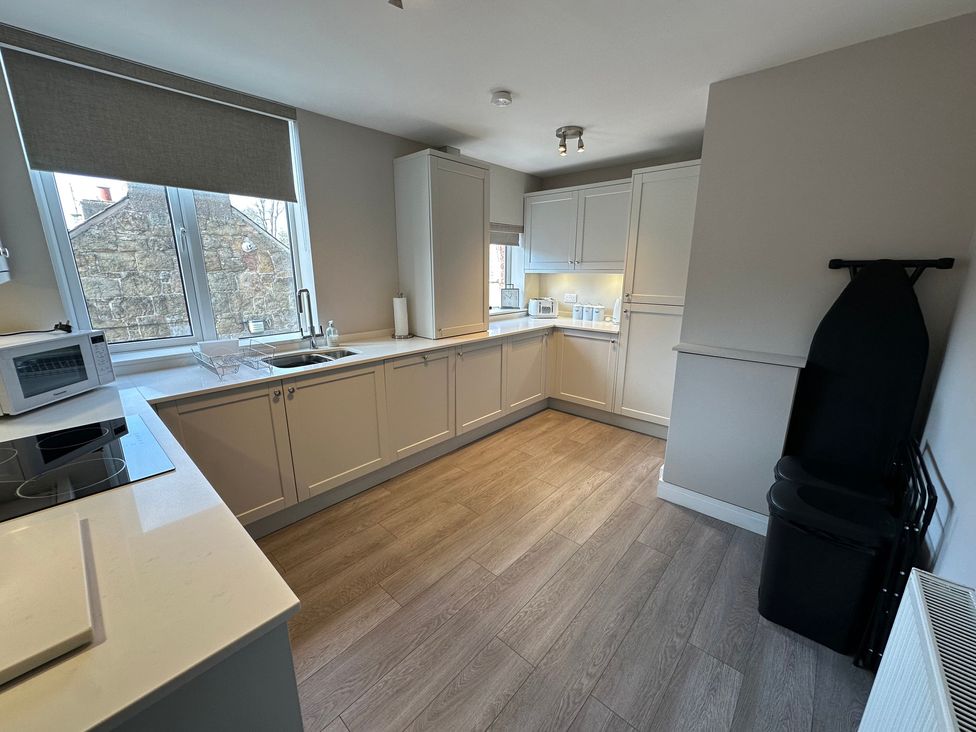 A kitchen with cabinets and a countertop at The Clyde in 