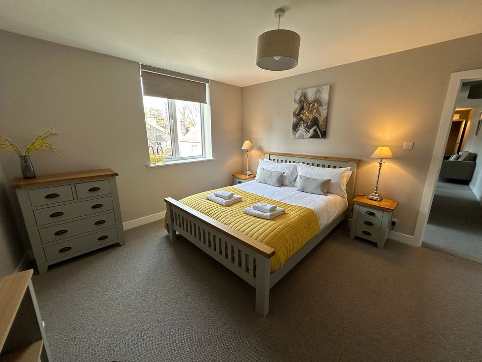 A bedroom with a bed and dresser at The Clyde