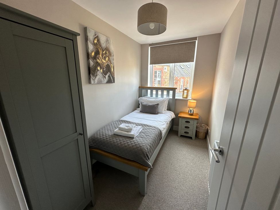 A bedroom with a single bed and wardrobe at The Clyde