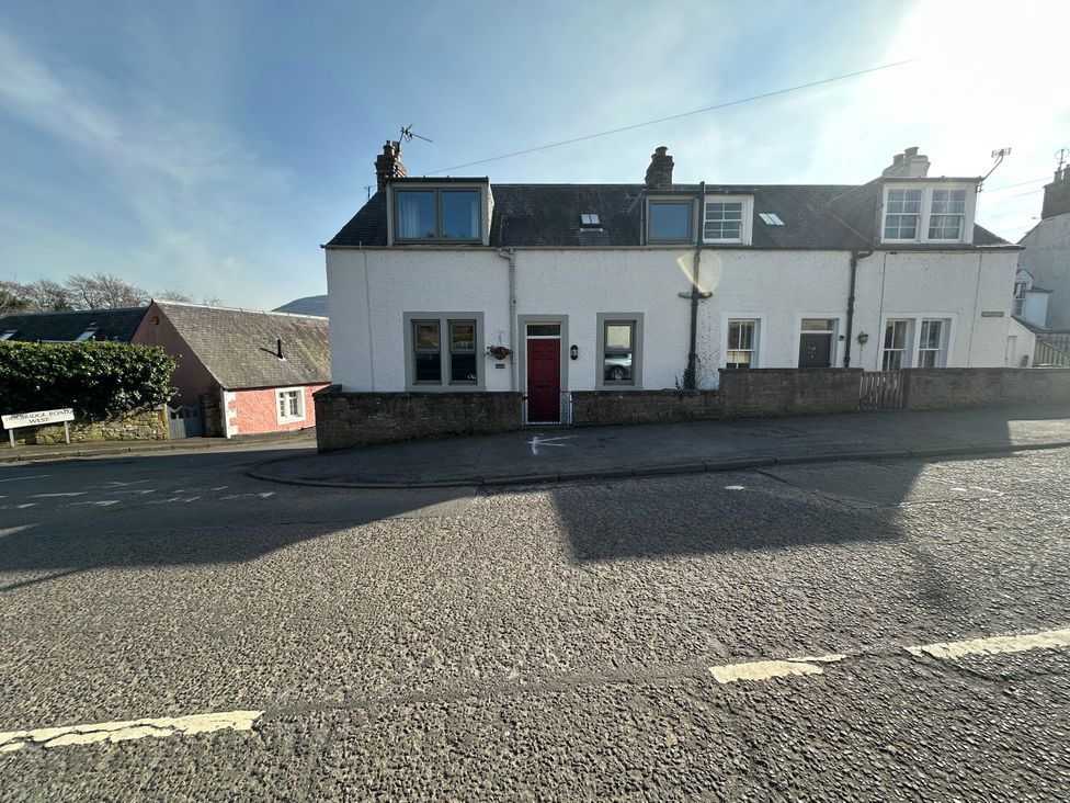 A house with a red door and windows located on a street at Pergola in Melrose