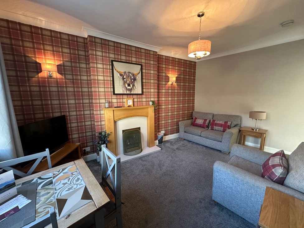 A living room with a sofa and television at Pergola in Melrose