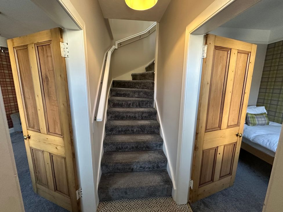 A stairway with doors on either side leading to rooms at Pergola in Melrose