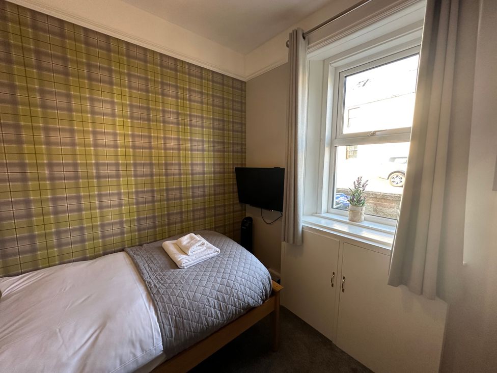 A bedroom with a bed and a television at Pergola in Melrose