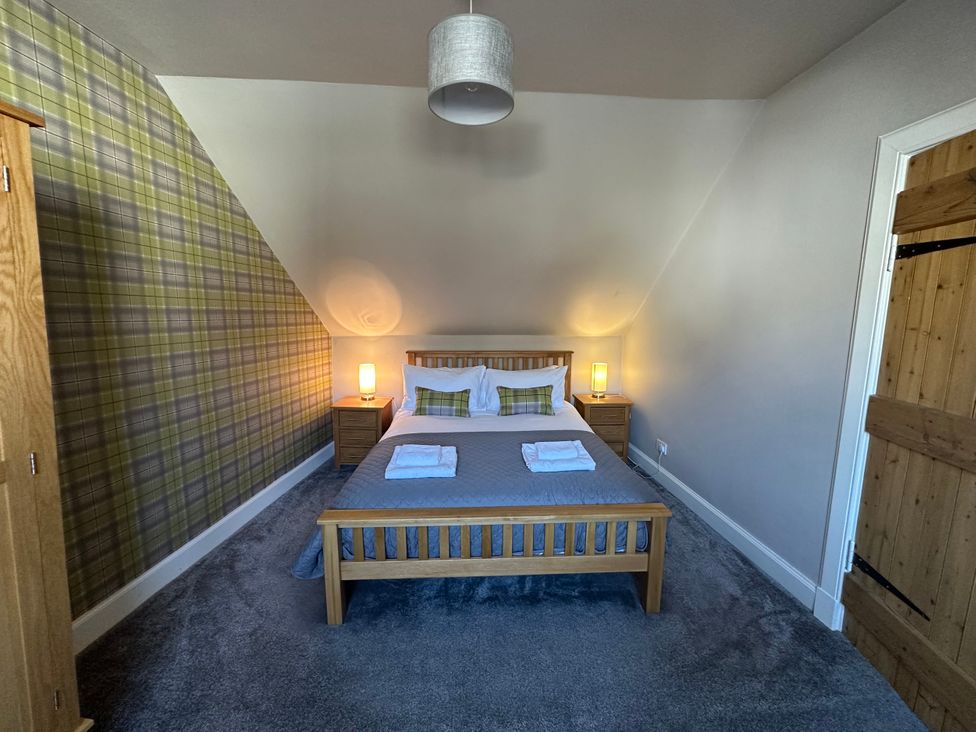 A bedroom with a bed and nightstands at Pergola in Melrose