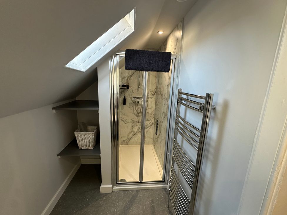 A bathroom with a shower and towel rack at Pergola Melrose