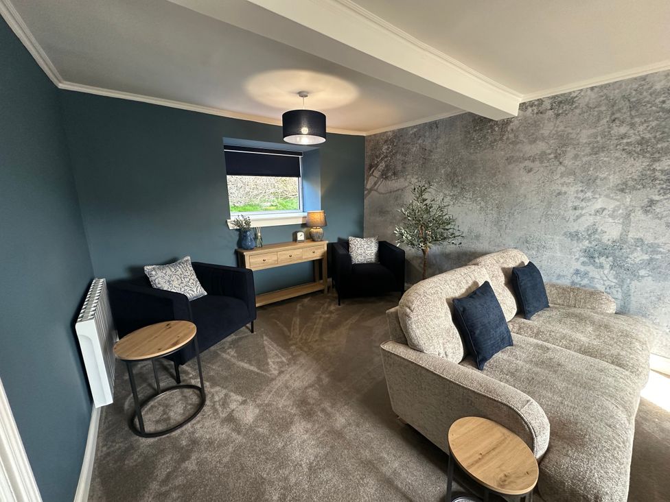 A living room with a sofa and armchairs at Broombank in Melrose