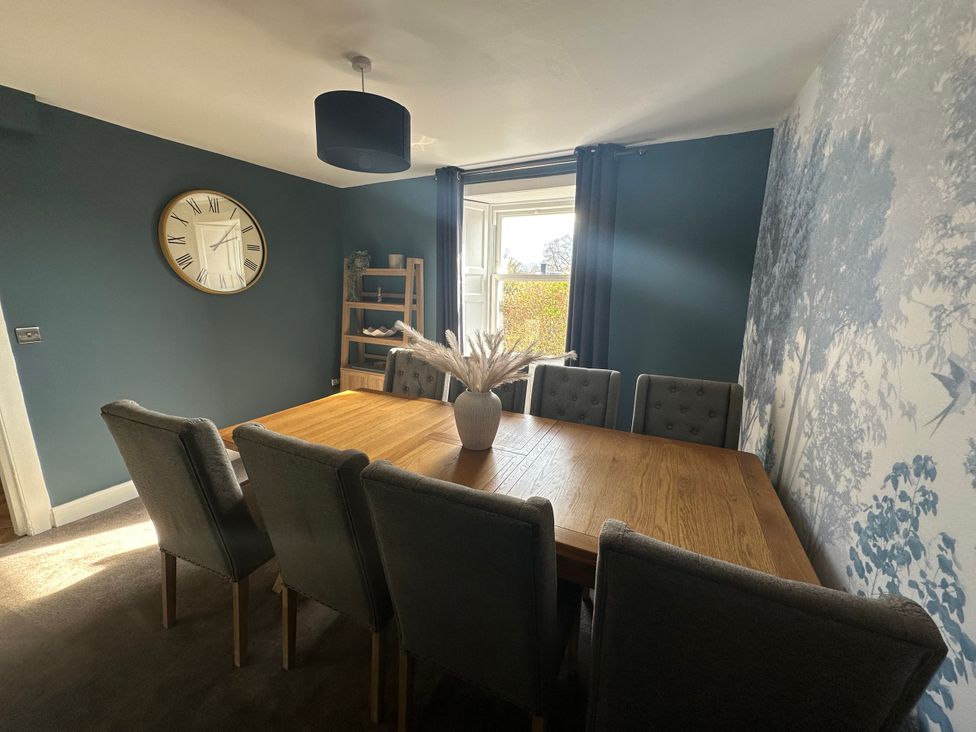 A dining room with a wooden table and chairs at Broombank in Melrose