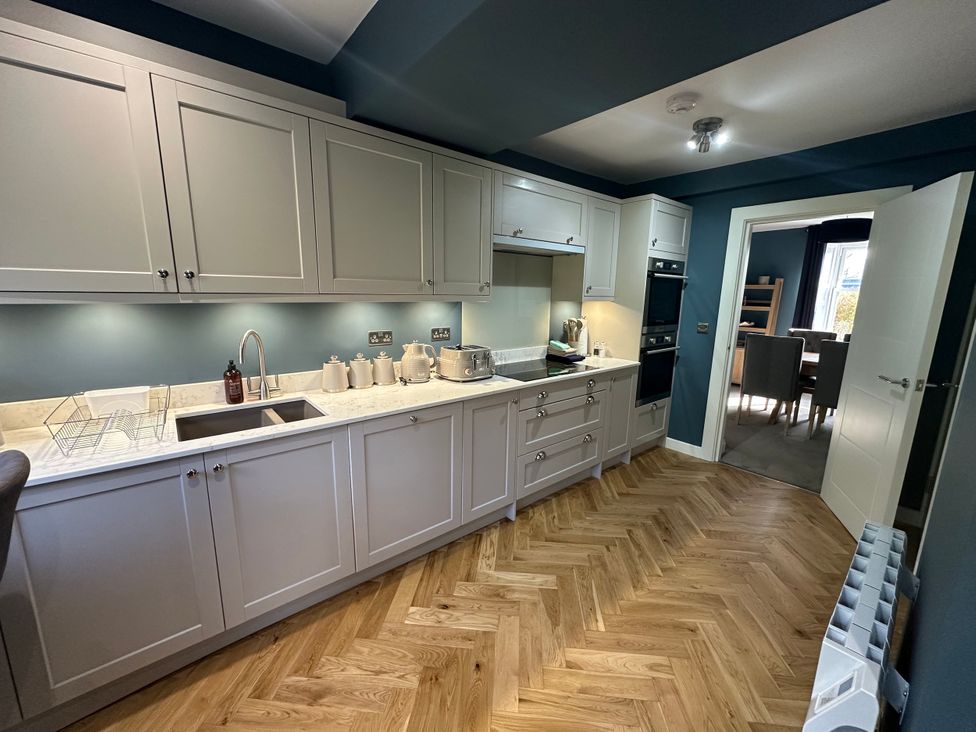 A kitchen with cabinets and appliances at Broombank in Melrose