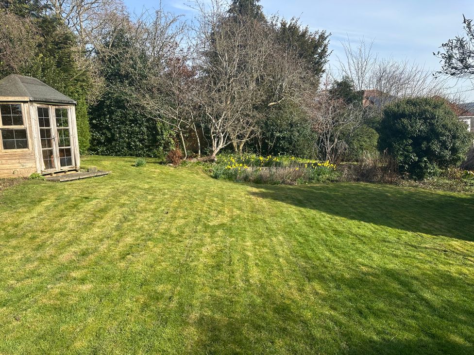 A garden with a shed and flowers at Broombank in Melrose