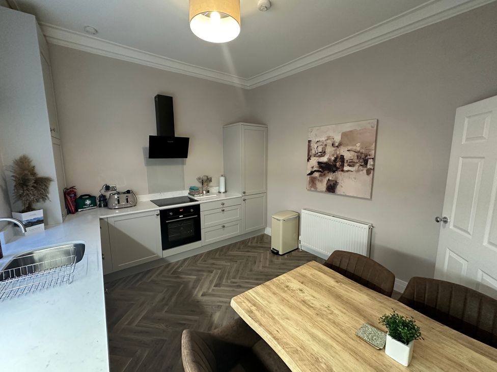 A kitchen with a table and chairs at Horsemarket in Kelso