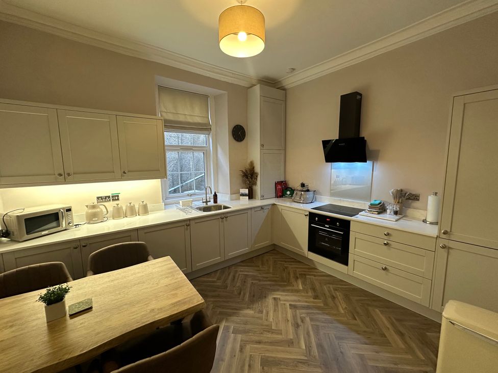 A kitchen with a table and chairs at Horsemarket in Kelso