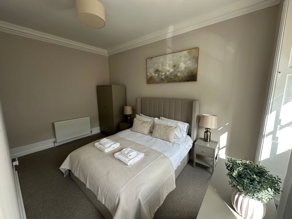 A bedroom with a double bed and wardrobe at Horsemarket in Kelso