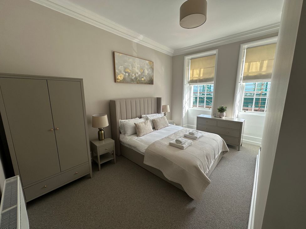 A bedroom with a bed and furniture at Horsemarket in Kelso