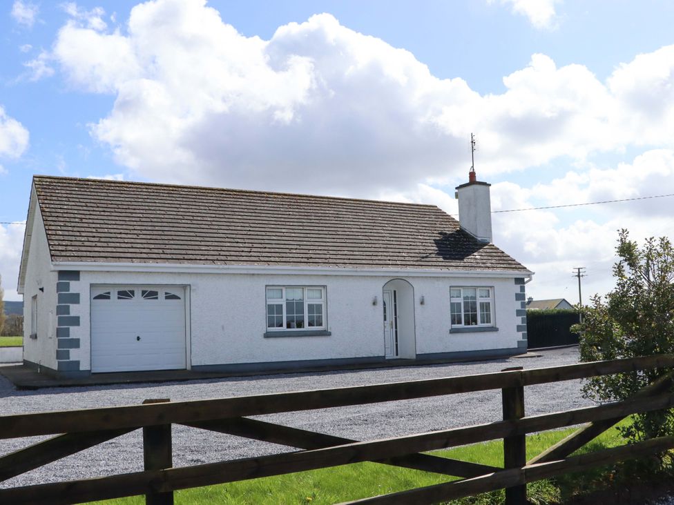 A house with a garage and yard at BREAGHMORE