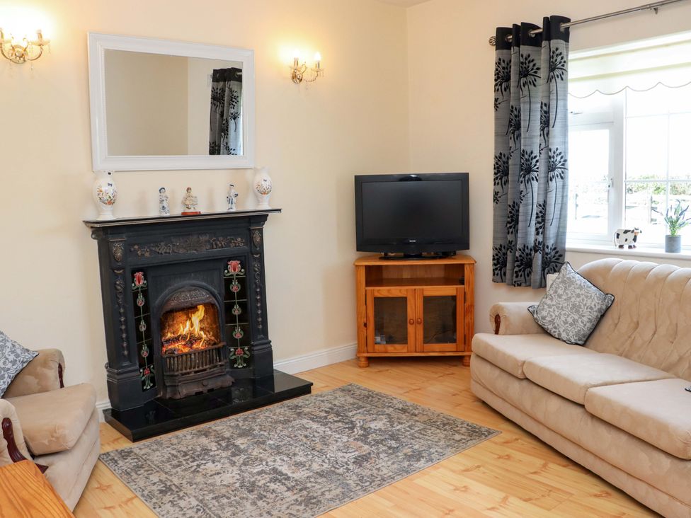 A living room with a fireplace and television at BREAGHMORE