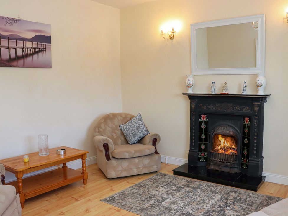 A living room with an armchair and fireplace at BREAGHMORE