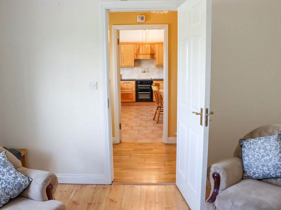 A view from a living room into a kitchen at BREAGHMORE