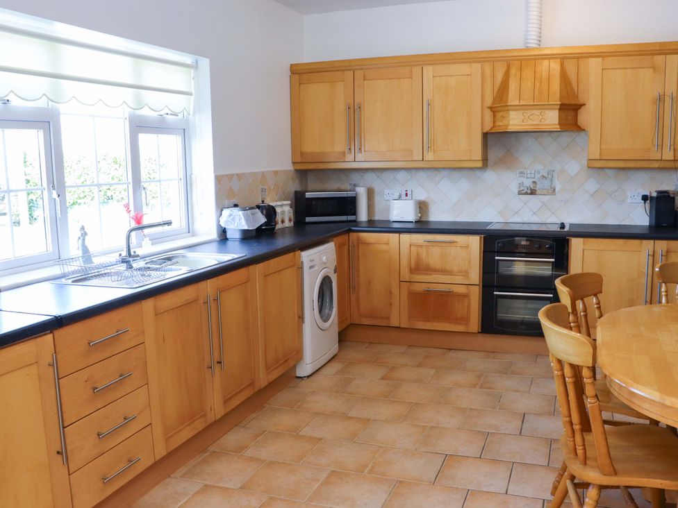 A kitchen with cabinets, sink, and appliances at BREAGHMORE