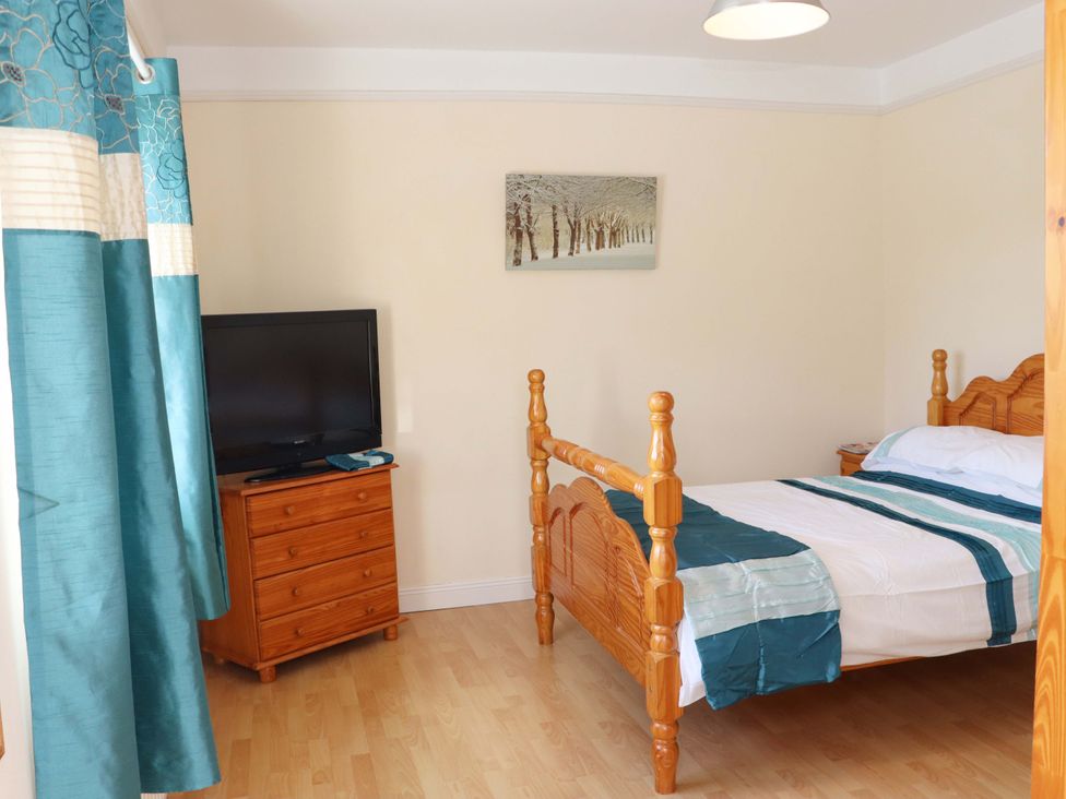 A bedroom with a bed and television at BREAGHMORE