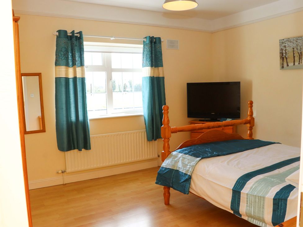 A bedroom with a bed and television at BREAGHMORE