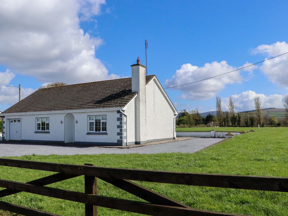 A house with a lawn and fence at BREAGHMORE